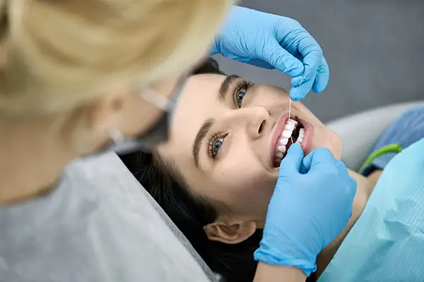 A woman at Osborne Dentistry in Lebanon, OR receiving a flossing during a dental visit