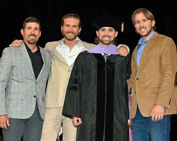 Dr. Kevin Osborne from Osborne Dentistry in Lebanon, OR at graduation ceremony with sons